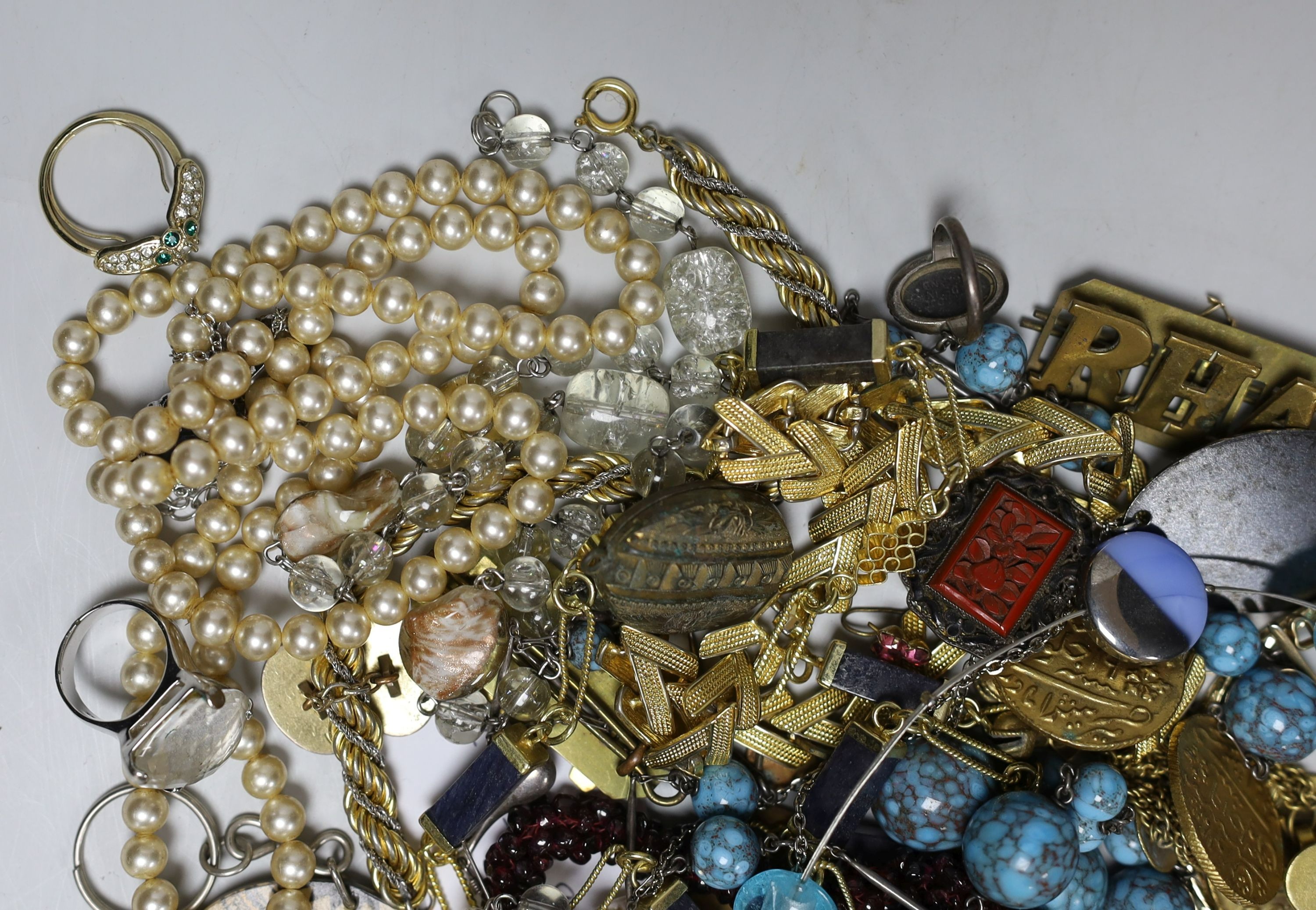 A quantity of assorted costume jewellery and other items including silver and enamel plaque and a garnet bead necklace.